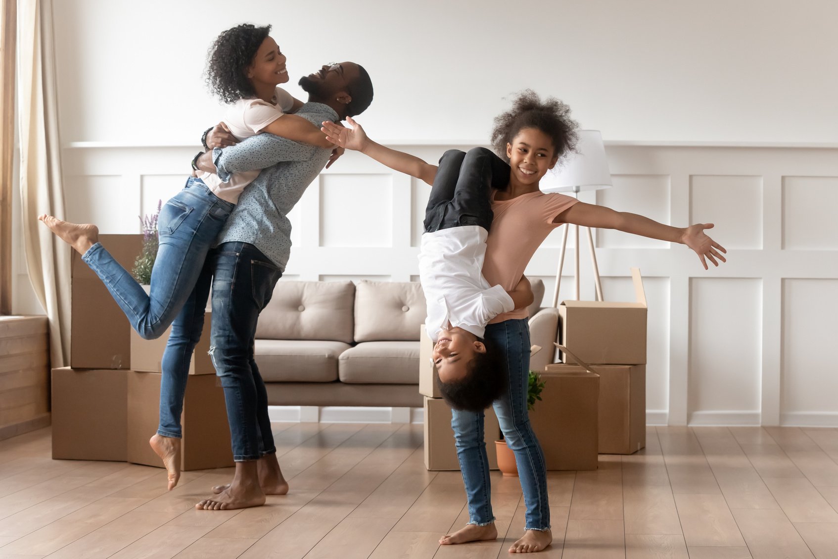 Funny mixed race family celebrating moving day.