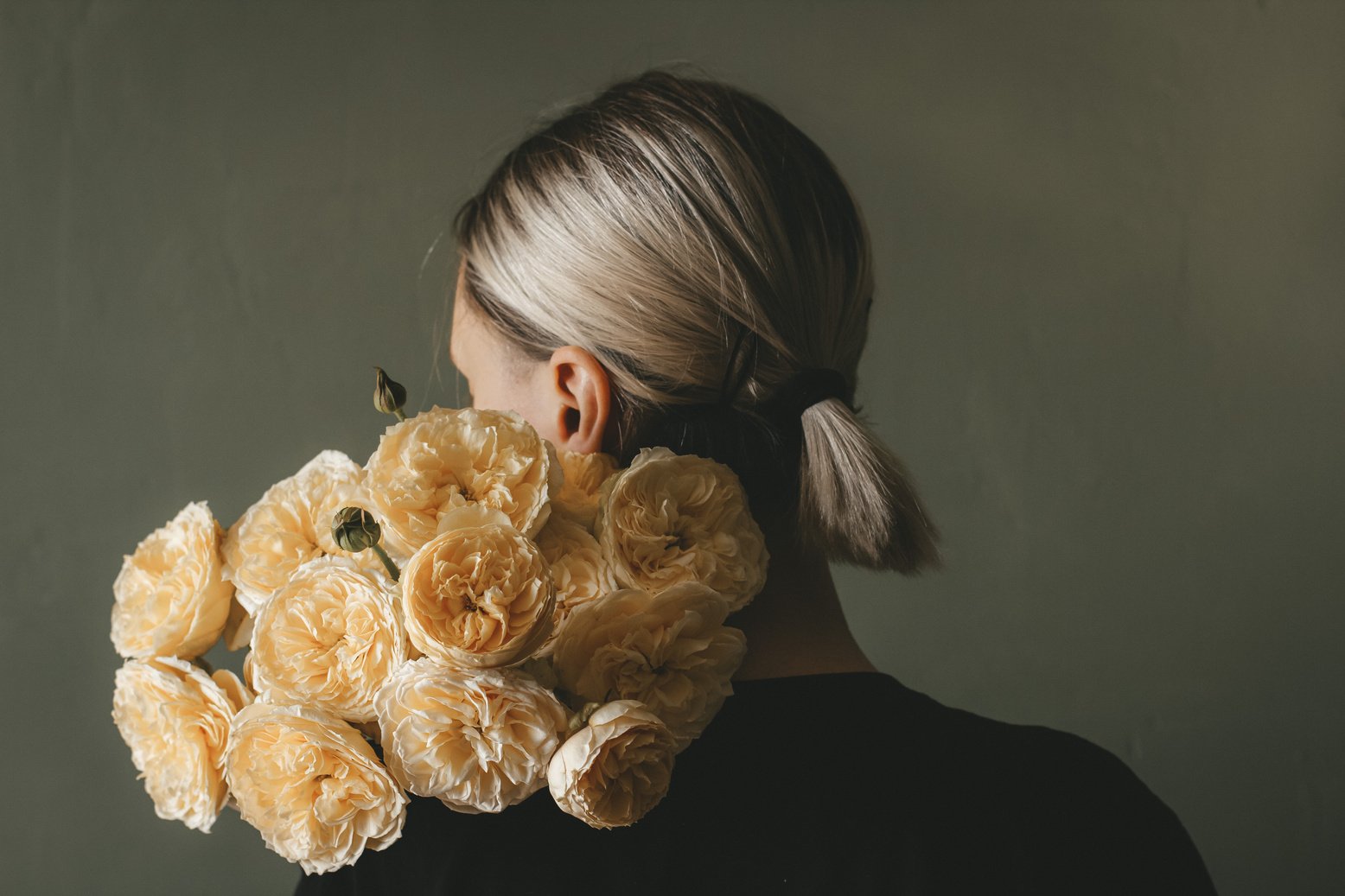 Faceless woman with bouquet of flowers